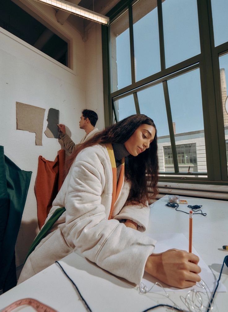 A recruiter working quietly at a desk in a naturally lit studio